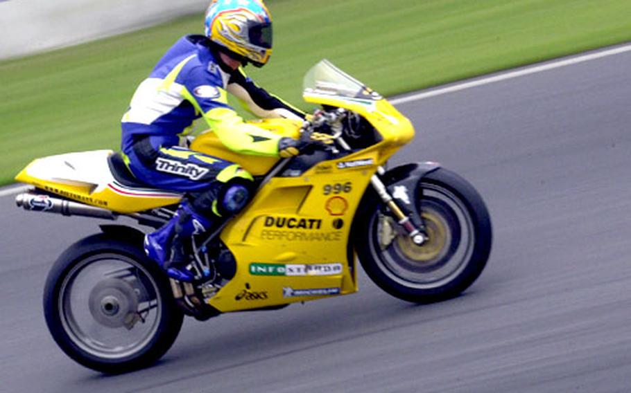 A rider accelerates on a straightaway at Tsukuba Circuit race track.