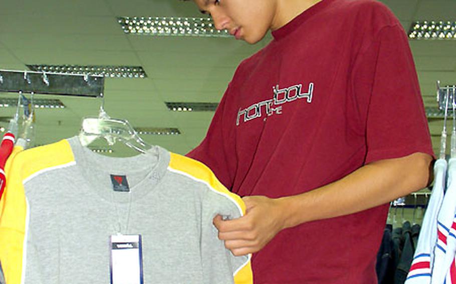 Richard Arad, 16, checks out the line of Vokal wear at the Hainerberg Post Exchange.
