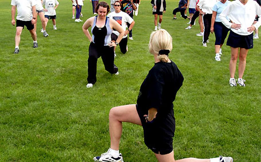 Lori Stewart demonstrates a stretching exercise at the fitness boot camp.