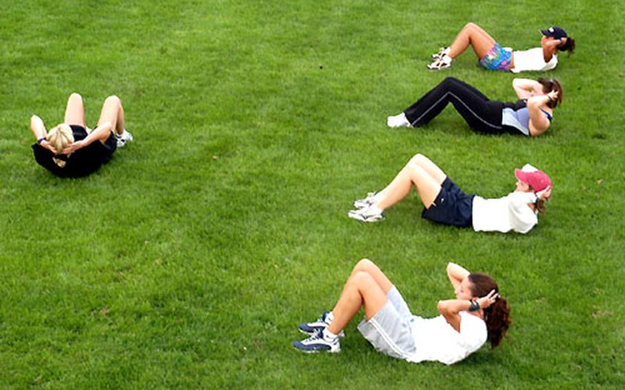 Lori Stewart demonstrates an exercise in front of (from bottom) Karen Corey, Holly Hanson, Jennifer Daszczyszak and Pia Morales.