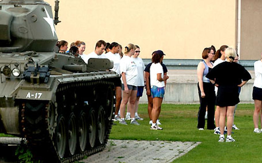 Boot campers get ready for a 15-minute run at an “Old Ironsides” 1st Armored Division sports field at Wiesbaden Army Airfield, Germany. Most of the “recruits” are military wives trying to get fit while gaining insight into their spouses’ lifestyles.
