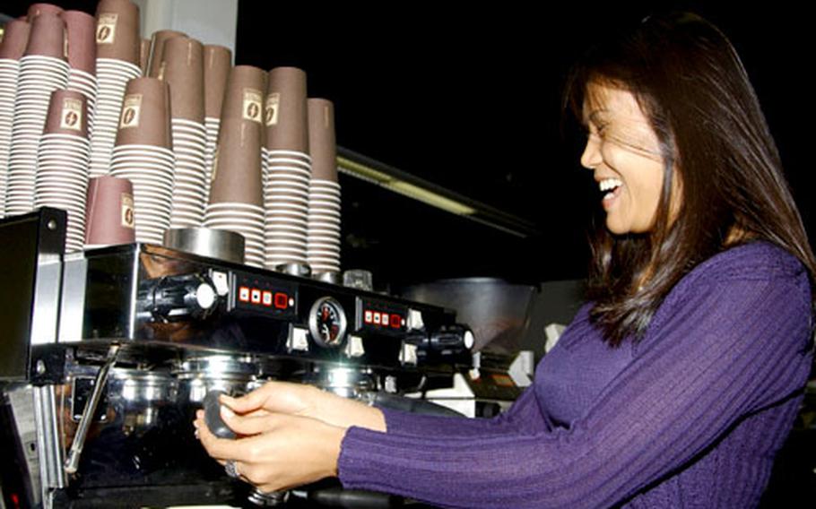 Jintana Ernst serves coffee with a smile at Frazer Coffee&#39;s location at the Community Connection at Rhein Main Air Base.