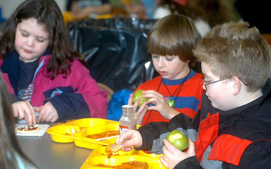 Meaghan Hennessy, 10, left, Jerryd Meek, 10, center, and Trenton White, 10, enjoy lunch at Liberty Intermediate School at RAF Lakenheath, England. Because of an increase in food allergies among children, schools must be alert for pupils ingesting dangerous food. Parents, school officials and staff, and students work together to make sure everyone is eating foods that are safe.
