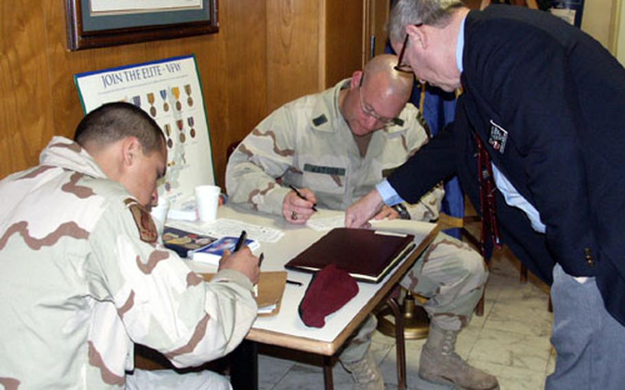 Don Lawery, quartermaster for VFW Post 8862 in Vicenza, Italy, signs up two Iraq war veterans for membership in the Veterans of Foreign Wars during the organization’s recruiting drive in Vicenza, Italy, in April.
