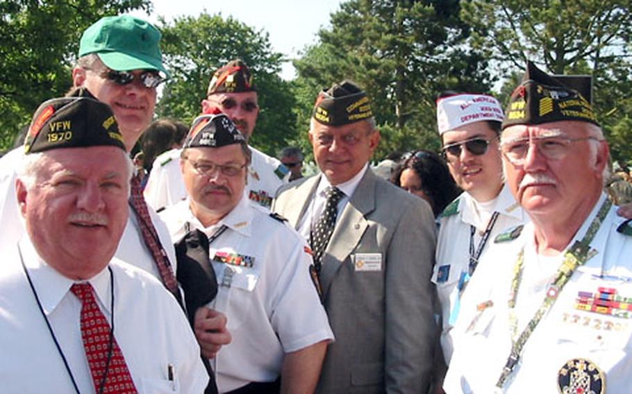 From left: John Furgess, national Veterans of Foreign Wars commander (2004-2005); Robert E. Wallace, executive director of the VFW Liaison Office, Washington, D.C. (in green hat); Peter H. Luste, senior vice commander, VFW Department of Europe; Dean White, (behind Luste) VFW commander (2003-2004) Department of Europe; Ed Banas, (center, in gray suit) national VFW commander (2003-2004); Todd Ota, former VFW Department of Europe commander; and Richard Kennedy, VFW Department of Europe commander.