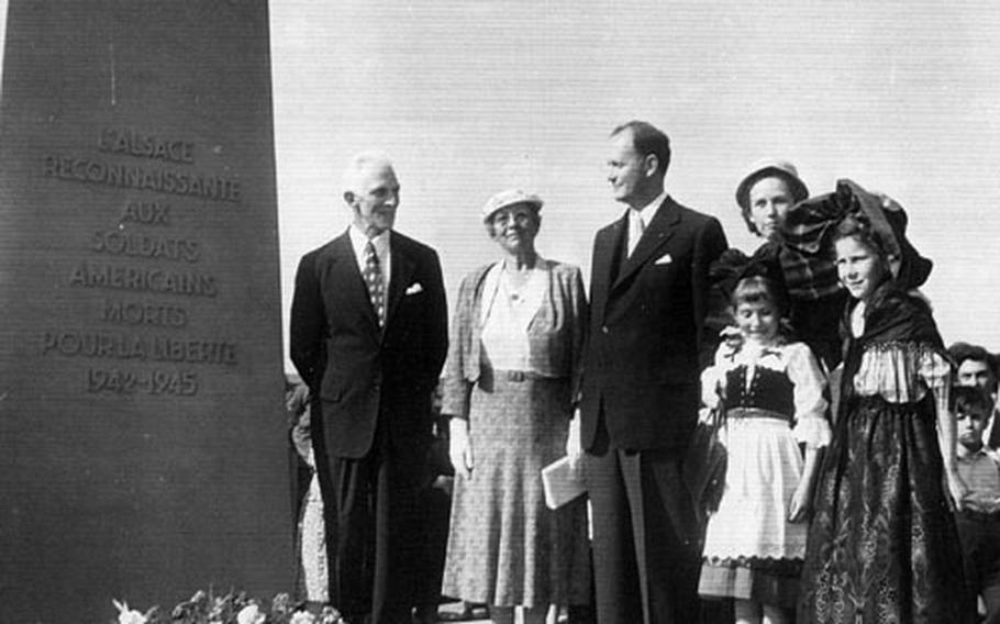 The unveiling of a monument in Hochfelden, Germany, honoring U.S. servicemembers who died in the liberation of France during World War II, on June 7, 1953. From left are John Rahill&#39;s parents, Gerald D. and Clara A. Rahill; C. Douglas Dillon, U.S. ambassador to France; Dillon&#39;s wife, Phyllis; and some children in traditional Alsatian dress.