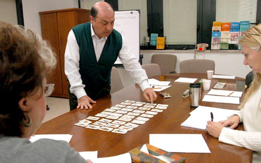 Del Giacco lays out all 40 cards in a deck of “carte Napoletane,” or Neapolitan cards — the type of cards needed to play Scopa.
