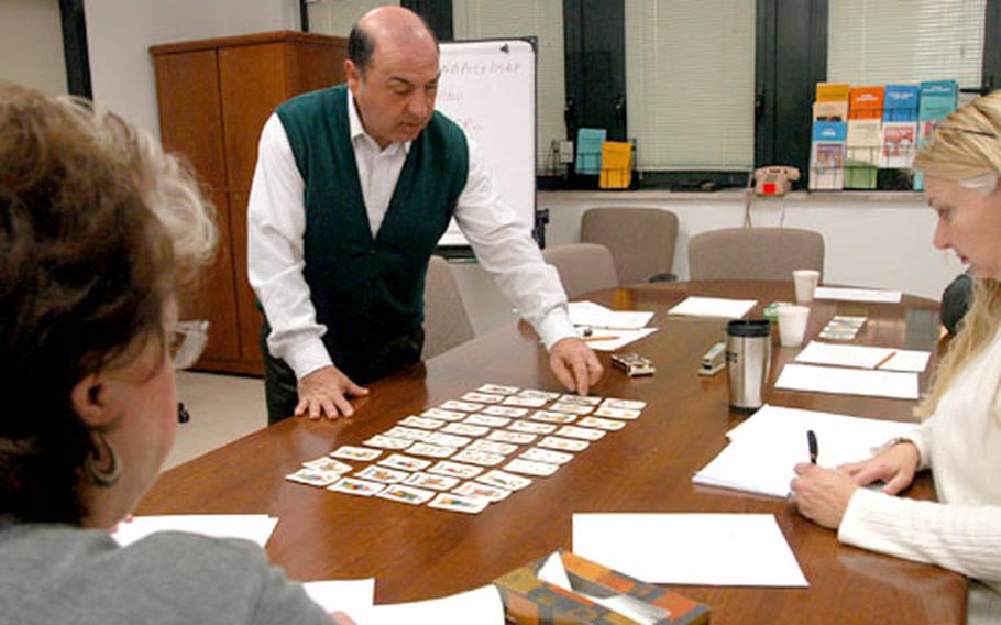 Del Giacco lays out all 40 cards in a deck of “carte Napoletane,” or Neapolitan cards — the type of cards needed to play Scopa.