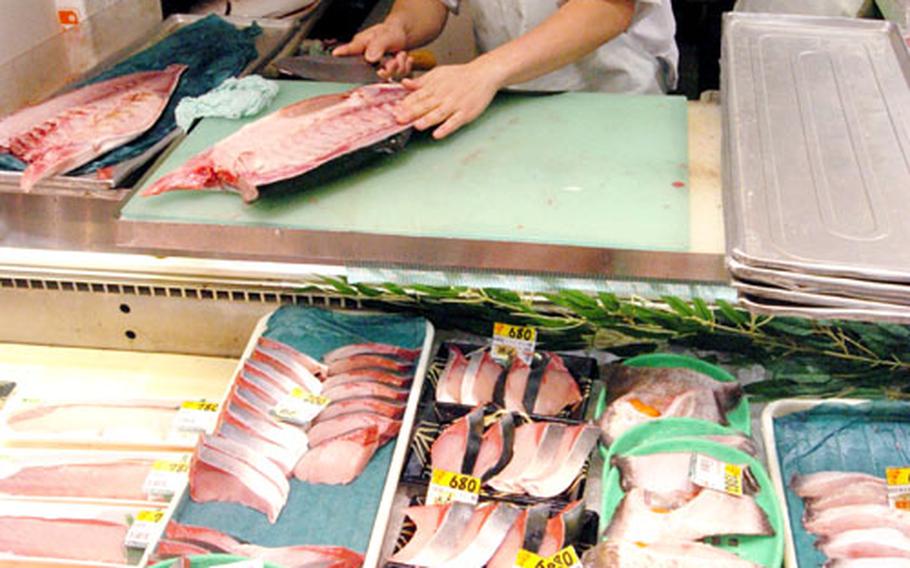 Customers can see fresh fish cut right in front of them.