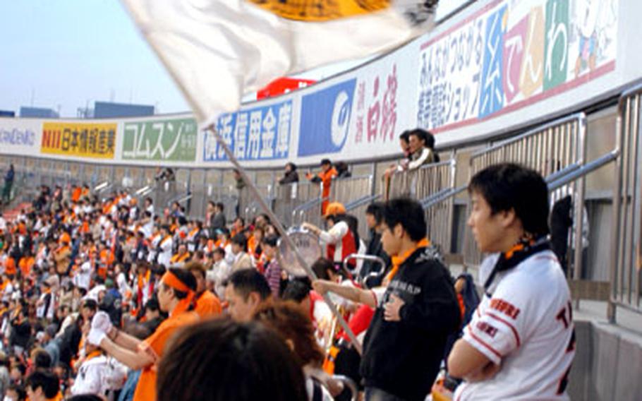 Japanese fans are known for waving huge banners to spur their teams to victory. A fan of the Yomiuri Giants gets a workout at a Giants vs. Yokohama BayStars game April 5.
