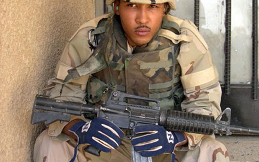 Sgt. Neal Saunders, aka Big Neal, poses in Baghdad. Saunders thought his deployment to Iraq would force him to postpone his music career. Instead, it inspired him.