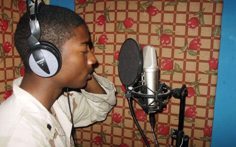 Sgt. Ronin Clay records in a makeshift studio in an Army barracks in Baghdad. Extra mattresses were used to help soundproof the studio, which is outfitted with equipment shipped from the States.