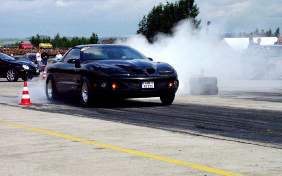Master Sgt. Bruce Sweeney of the 615th Military Police Company in Grafenwöhr smokes his tires before a quarter-mile drag race June 4 at the Bitburg airport.