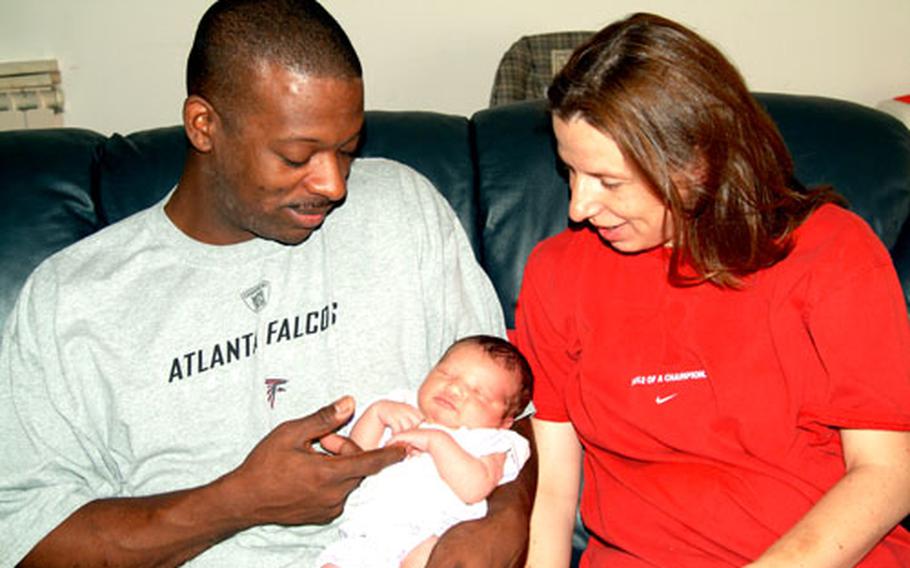 Staff Sgt. Wilma Allen and Sgt. Michael Allen relax with their new child, Emily Allen, who was born June 14. Emily was the first child born in the Dr. Frank V. Benincaso Mother and Infant Pavilion, a new birthing center at Caserma Ederle, Vicenza, Italy.