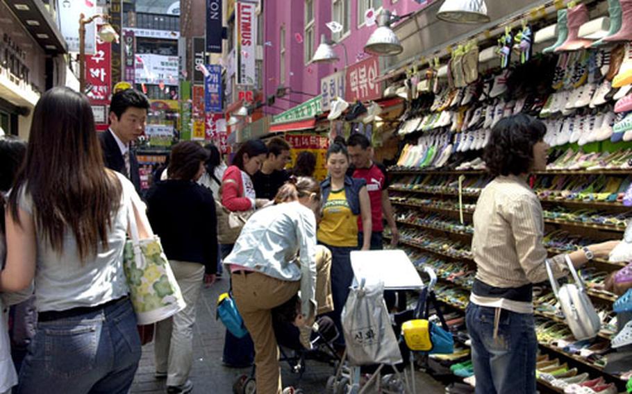 It’s standing-room-only in an outdoor shoe store in Seoul’s Myeongdong district.