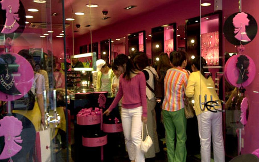 Customers browse through a colorful store in Myeongdong.
