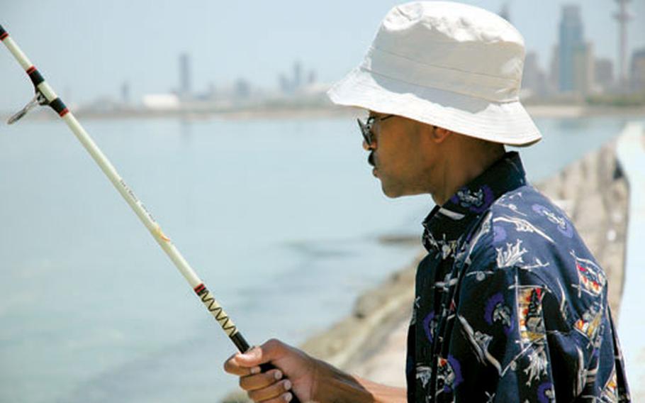 Quarles fishes in Kuwait City in a park near Shawaikh Port. He says he mainly catches a fish that closely resembles a catfish, but with beautiful, mother-of-pearl-colored scales.