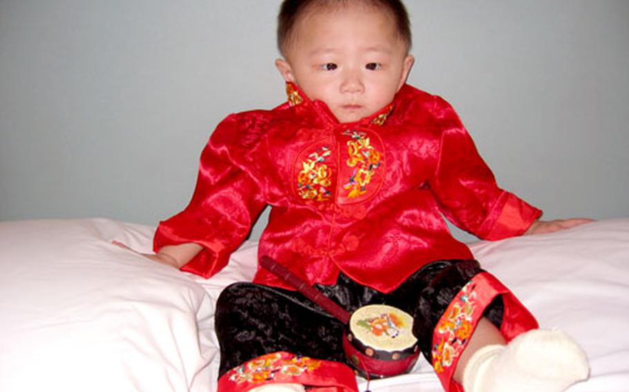 Baby Lydia poses in her finery, a silk suit purchased that very morning in Nanchang.