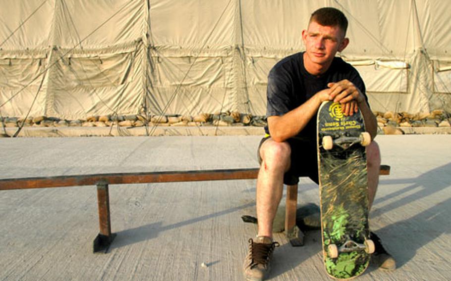 Spc. Lowell Passons sits on his homemade skateboard grind rail at the 173rd Forward Support Battalion motor pool at Kandahar Airfield, Afghanistan. An avid skateboarder, Passons found pieces of scrap metal and welded them together for the rail.