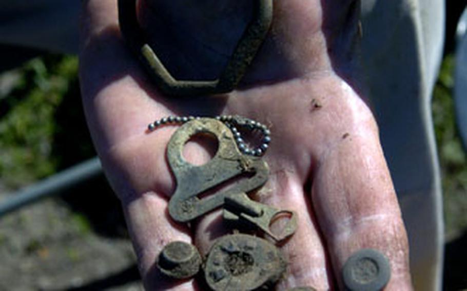 Artifacts found at the site include uniform buttons, dog tag chains and life-support equipment.