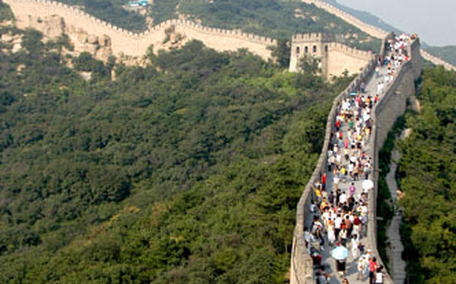 The Great Wall at Balading, where thousands of tourists come each day. To get up to the wall, most people ride a slow-moving roller coaster to avoid the hike. Once on the wall, people can walk to the highest guard post more than a kilometer away.
