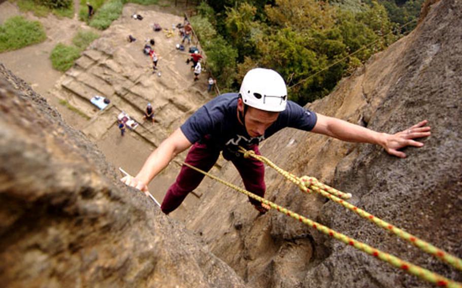 Airman 1st Class Jesse McCabe of Yokota Air Base’s 374th Comptroller Squadron steadies himself at the top of a rock’s “open-book,” named for its appearance, on Mount Takatori, Japan. He was among a group from Yokota who took part in a recent rock-climbing expedition sponsored by the Outdoor Recreation Department.