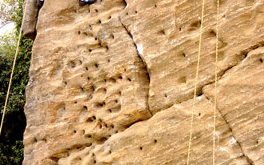 Ethan Poulton, 7, a second-grader from Yokota West Elementary School, scales a 75-foot rock wall on top of Mount Takatori.