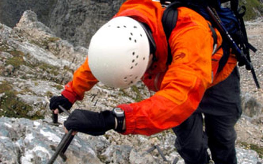 Helmut Grüninger, a weekend warrior from Munich, uses steel cables to climb up the peak of the Alpspitze Mountain.