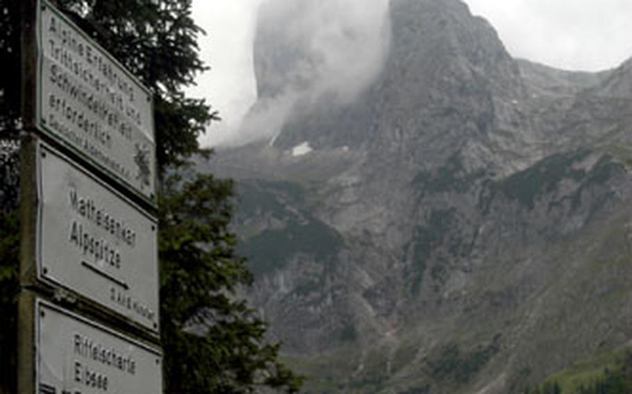 The mighty Zugspitze, the tallest mountain in Germany at 9,718 feet, looms in the the distant fog from a mountaintop hut.