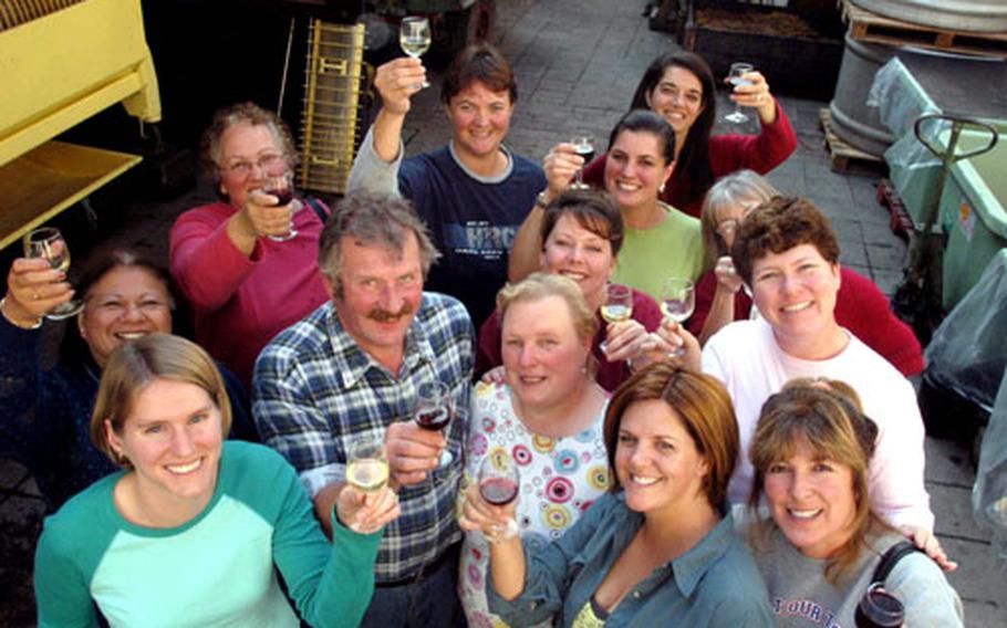 Vintner Helmut Rappenecker and his wife, Erika, center, toast with their visitors of the Wiesbaden Community Spouses Club after a succesful day of grape picking. From left, back row: Lu Yanick, Kathy Bertsch, Alicia Faddis, Colleen Beazer and Stacey Hatfield. In the middle: Debbie Gracia, Sue McGarvey from Manchester, England (hidden) and Marde Mott. Foreground, from left: Molly Heatherly, Marie Muschek and Natasha Foster.