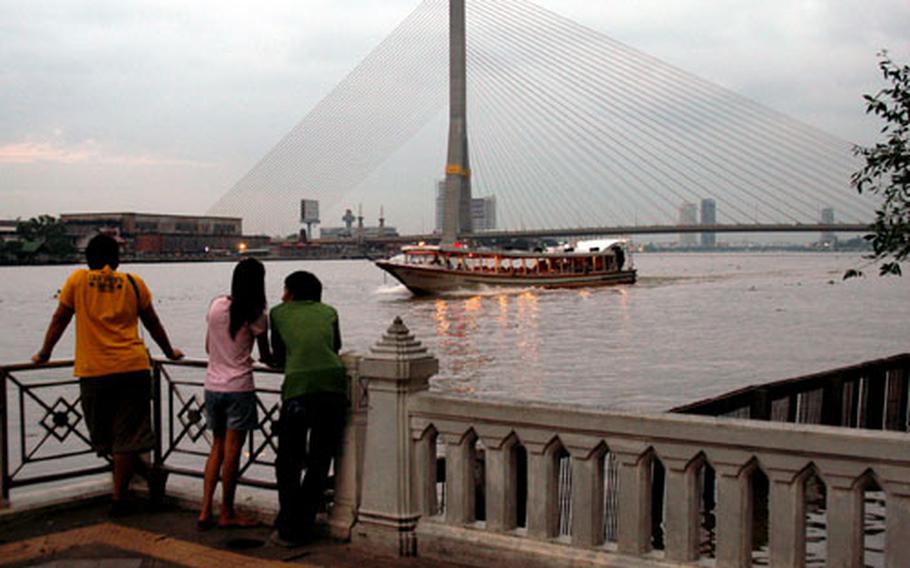The Mae Nam Chao Phraya runs south through Bangkok, providing a corridor for exports and water taxis. Here, people look out over the river from Santichaiprakan Park, home to an 18th-century fort built to defend the city against naval attacks.