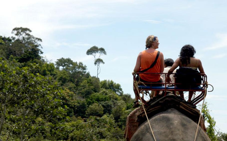 Travelers Michelle and Hema ride an elephant on a trek through a forest on Koh Lanta. The elephant is native to northern Thailand, but many are brought south to work as part of the tourist industry.