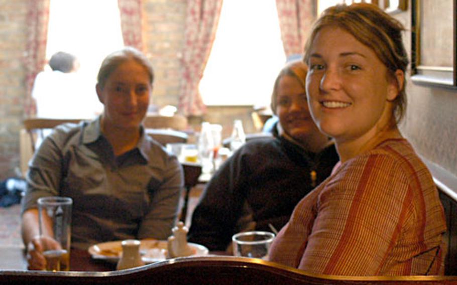 American exchange students, left to right, Jessica, Susannah and Ashley, share a pint and some gossip at the Minster Tavern in Ely, England.