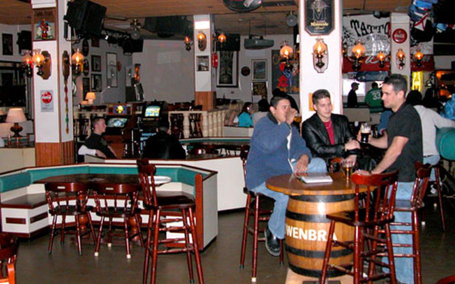 Patrons relax and converse at California Beer Parlor in Aviano, Italy.