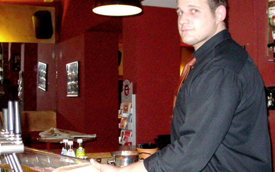 Bartender Dirk Specht serves up a “beer tower” at the Brauhaus am Markt in downtown Kaiserslautern.