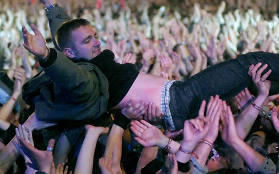 A happy concert-goer surfs along the densely packed crowd during the Franz Ferdinand performance at Rock am Ring.