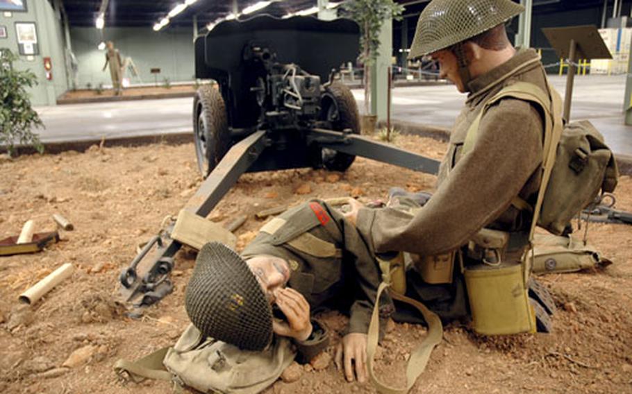 A soldier on the battlefield helps a wounded buddy in one of the scenes at the American Armoured Foundation Tank Museum.
