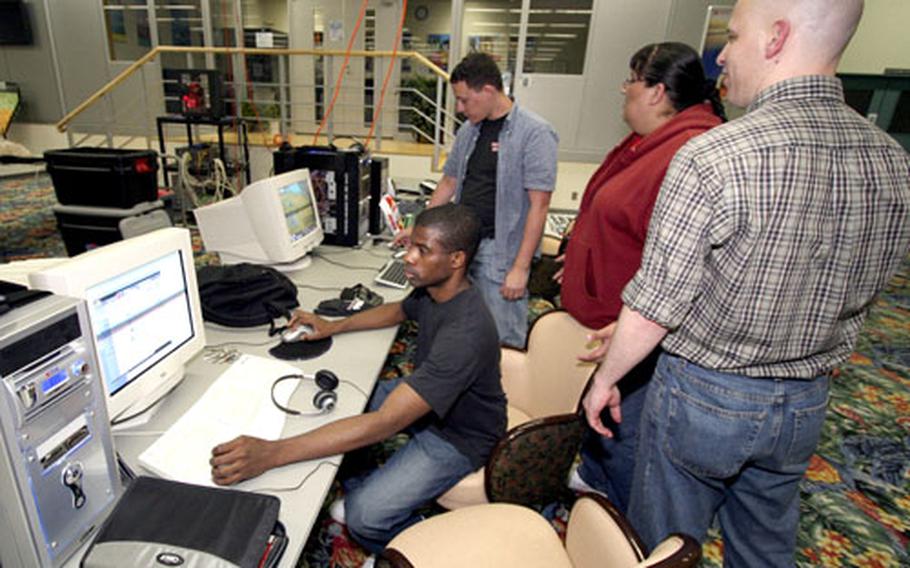 Computer Users Group of Yokota members wage battle in the video game world during a LAN party at the Yujo Recreation Center on Yokota Air Base, Japan.