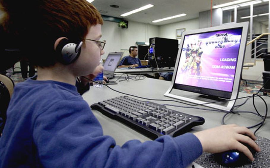 Nicolas Sanders, 8, the son of CUGY president Robert Sanders, tackles a video game during a LAN party.
