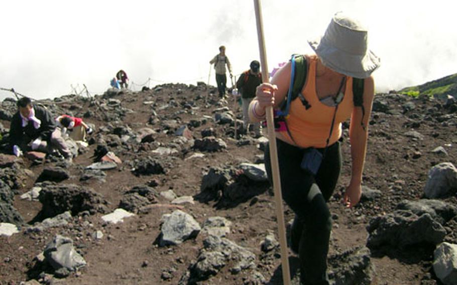 Yokosuka MWR Aquatics Director Carol Poole trudges up Mount Fuji during a recent climb.