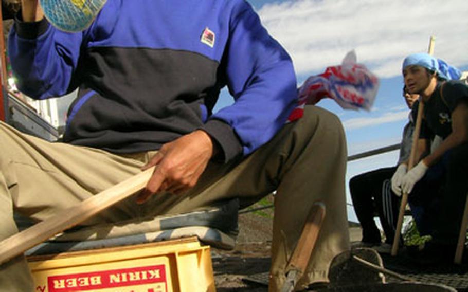 Each station on Mt. Fuji has a “stamper,” someone with a branding iron who will mark your walking stick to prove you reached that point. Each stamp cost 200-yen.