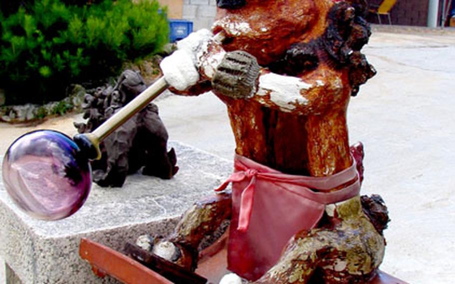 A glassblowing shishi lion, Okinawa’s traditional good fortune sculpture usually placed at the entrance to homes and businesses, greets visitors to the Mid-Air Glass Blowing Studio Rainbow in Yomitan, Okinawa.