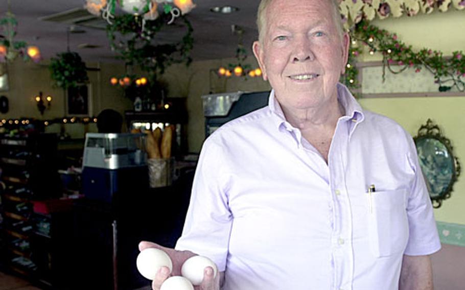 Ray Payne, the owner of the Rose Garden Italian restaurant, which is also known for its hearty breakfasts, shows off the size of the eggs used in omelets at the 8-year-old restaurant.