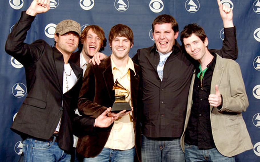 The members of Audio Adrenaline celebrate their second Grammy for best Gospel rock album at February’s awards ceremony. The winning CD, “Until My Heart Caves In,” was the band’s last studio effort.