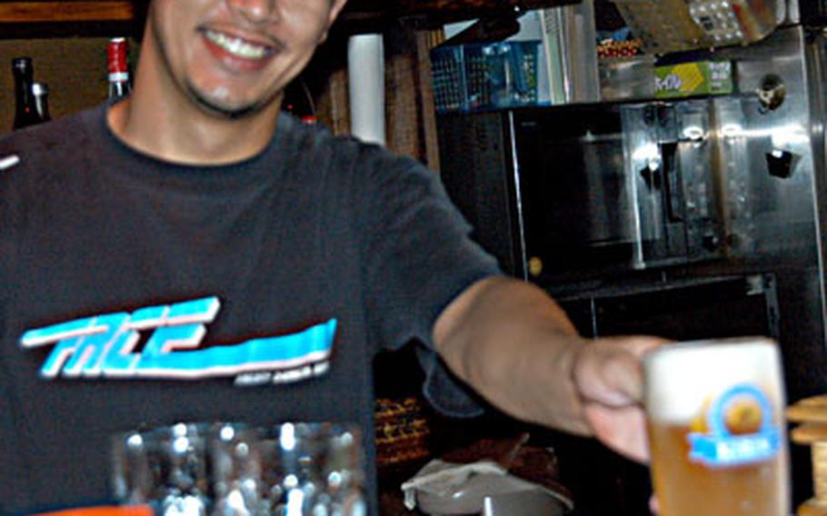 Pathammavong Sounthala, 26, owner of Chibi Bar in Ayase, Japan, fills a mug with Kirin draft at his establishment just outside Naval Air Facility Atsugi’s main gate.
