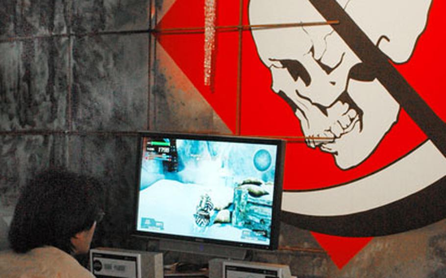 A gamer plays a multiplayer round of "Lost Planet", a new Capcom title for the Xbox 360, at the 2006 Tokyo Game Show. The show was a three-day event featuring the latest innovations from the video game industry.