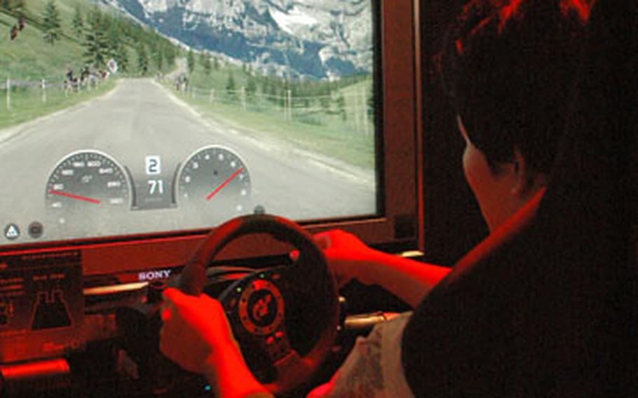 A gamer tries his hand at “Gran Turismo HD,” a racing game for the Sony Playstation 3.