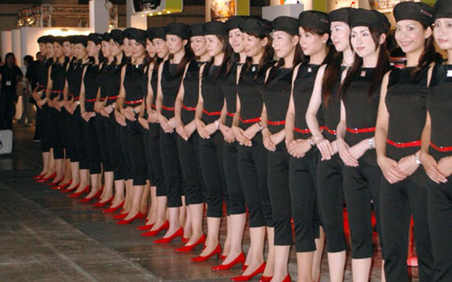 Sony booth attendants line up to bow at the end of the first day of the 2006 Tokyo Game Show.