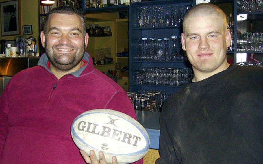 Rugby players Brian Openshaw of England, left, and 1st Squadron, 2nd Cavalry Regiment soldier Pvt. Walter Lilly, 20, of Belvidere, N.J., enjoyed a beer at Haus Ruckinger after a rugby practice.