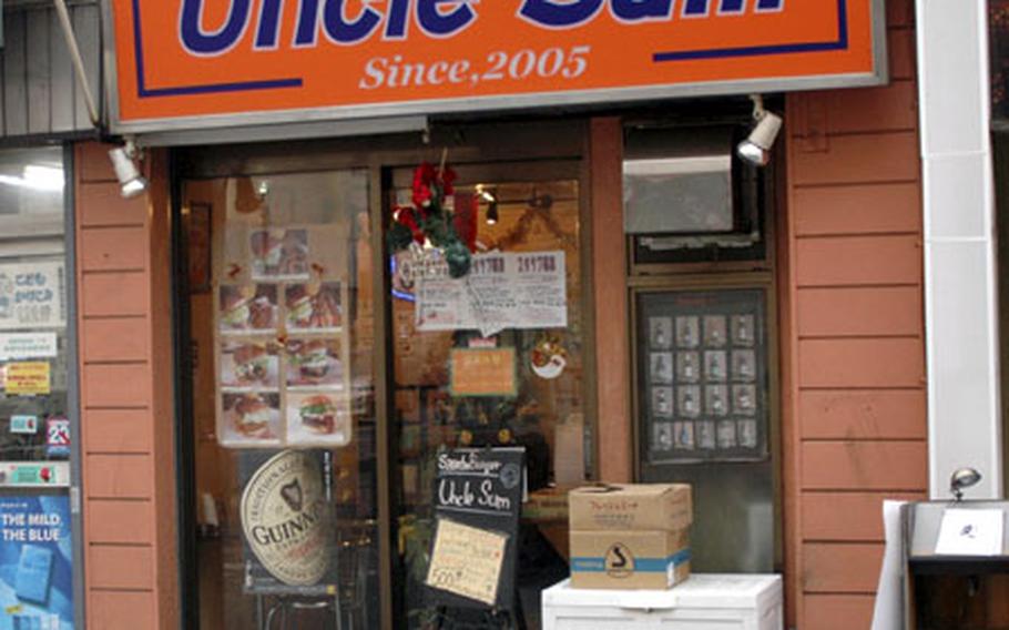 A bright sign announces the location of the Uncle Sum restaurant just outside Camp Zama, Japan. Uncle Sum serves burgers and beer (among other beverages), keeping things pretty simple.